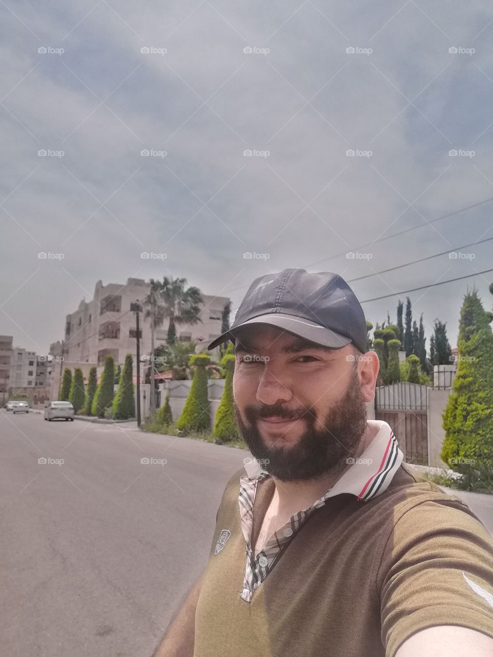 A young man with a beard and a hat 
شاب بلحية وقبعة