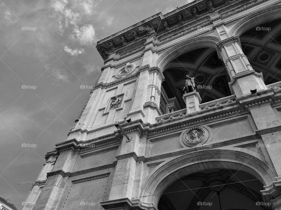 A beautiful black and white photo of an old opera building in Vienna, amazing architecture captured in black and white colours