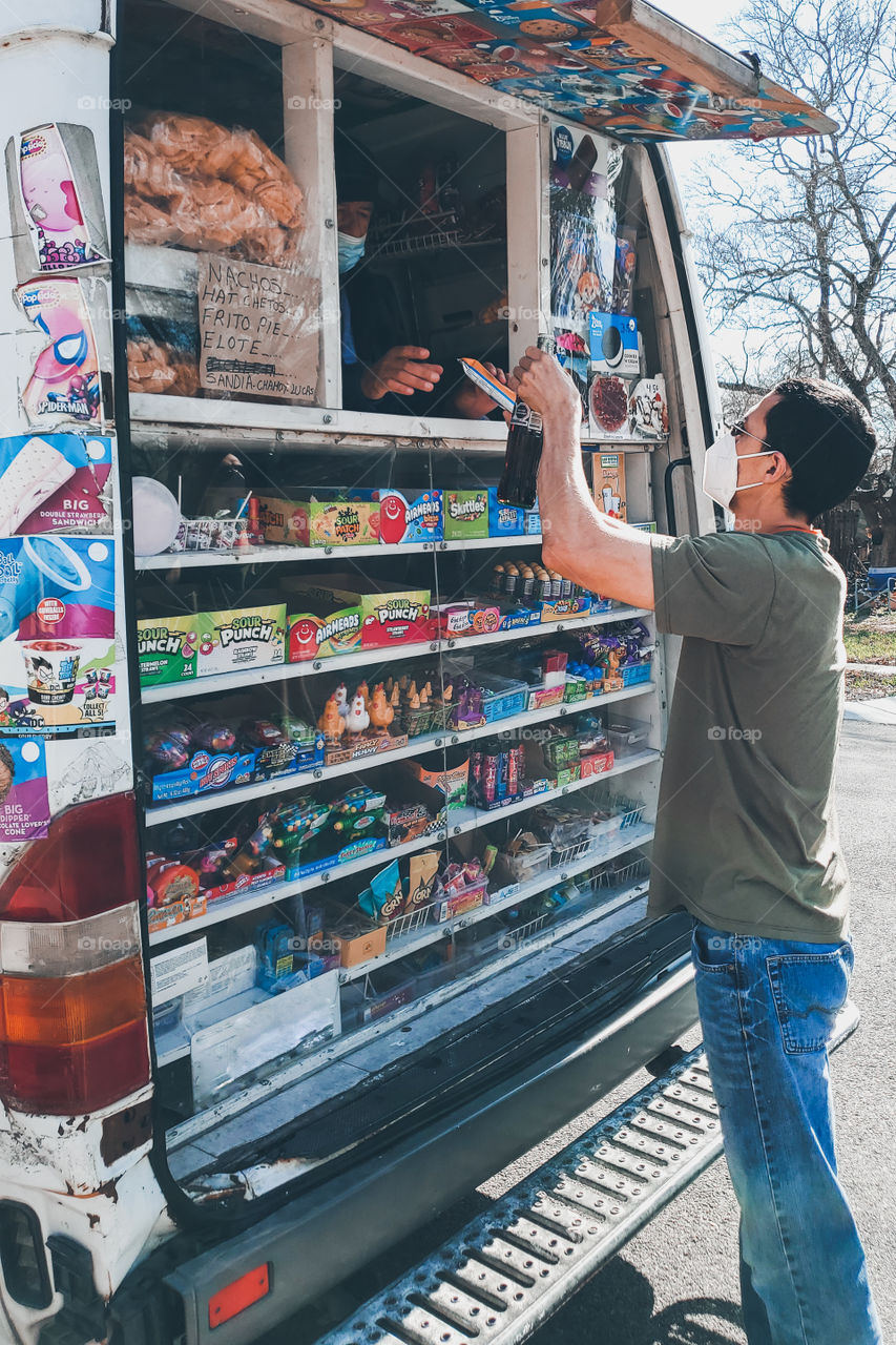 Man buying a bottle of Coca-Cola from the ice-cream truck during the 2021 pandemic.  no. 3