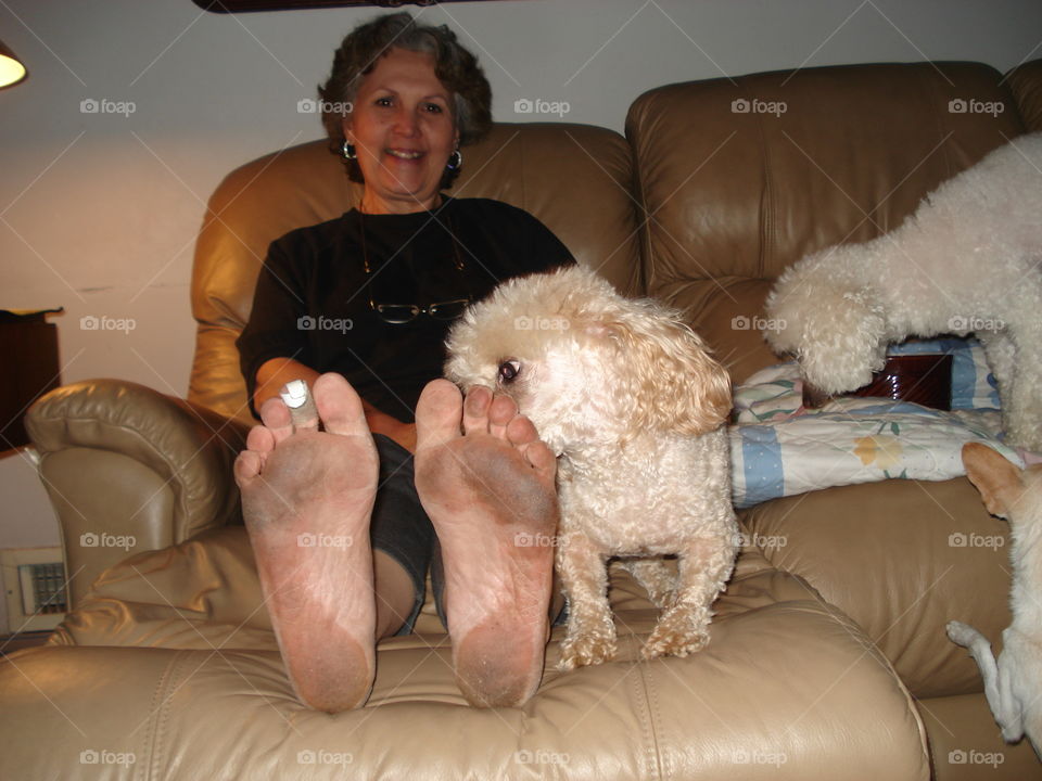 Barefoot & blistered day working outside, my puppy kissing me. Other pets on couch too.