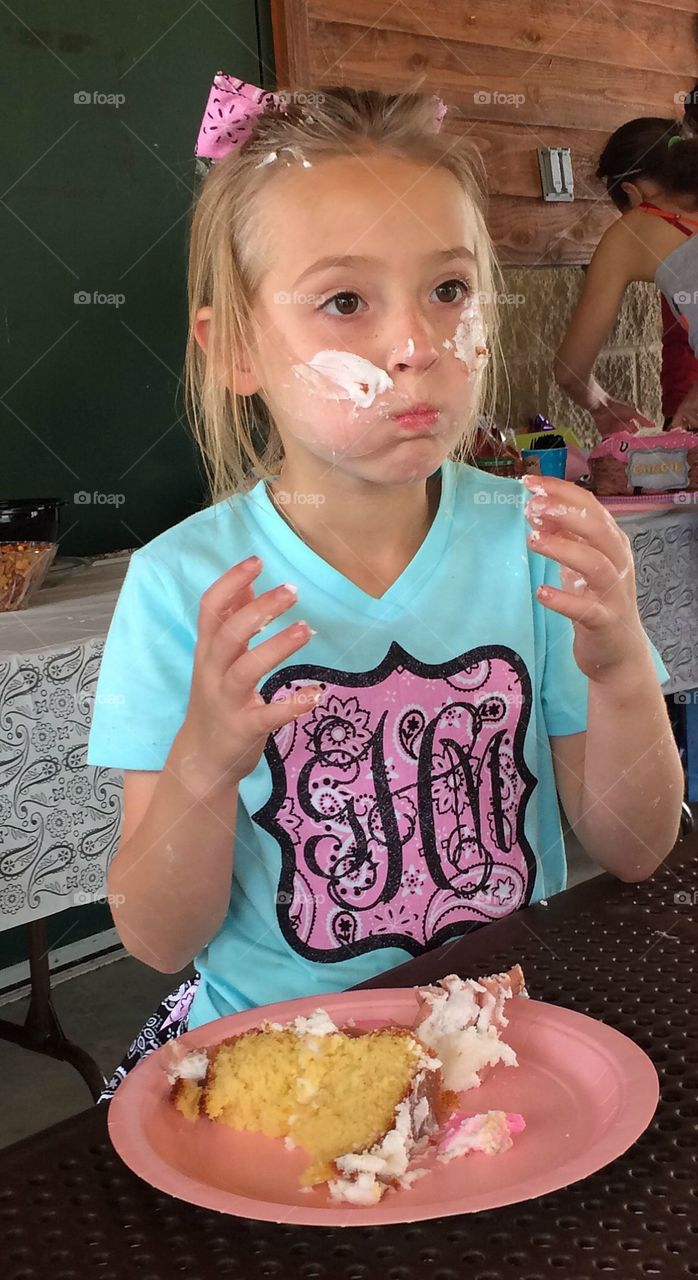 Little girl eating cake