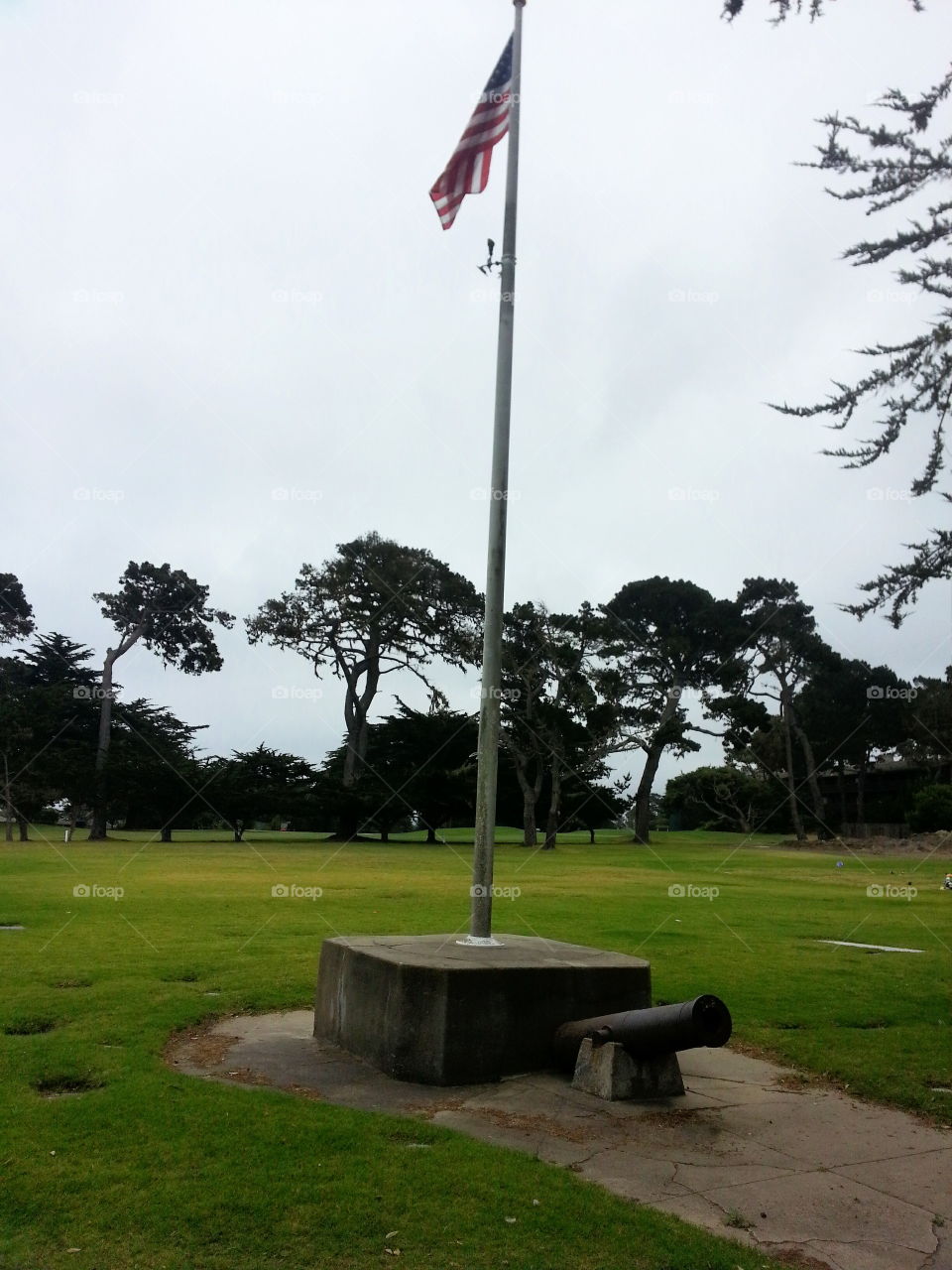 American flag mast with cannon. At a military cemetery in Pacific Grove, CA.