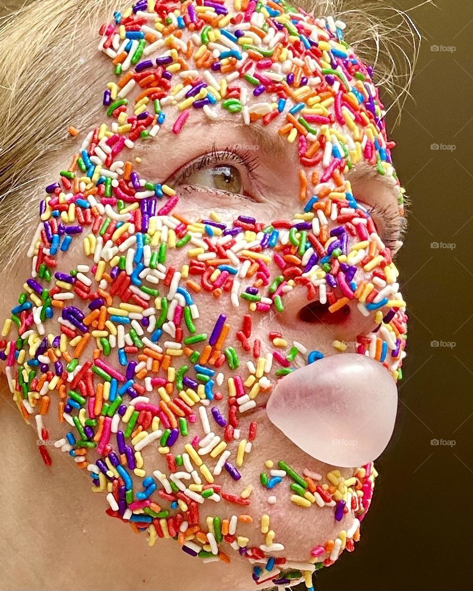 Candy sprinkles all over woman’s face 