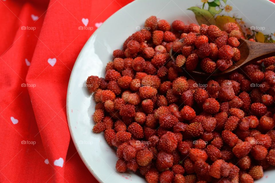 red strawberries on a plate tasty healthy summer food red background