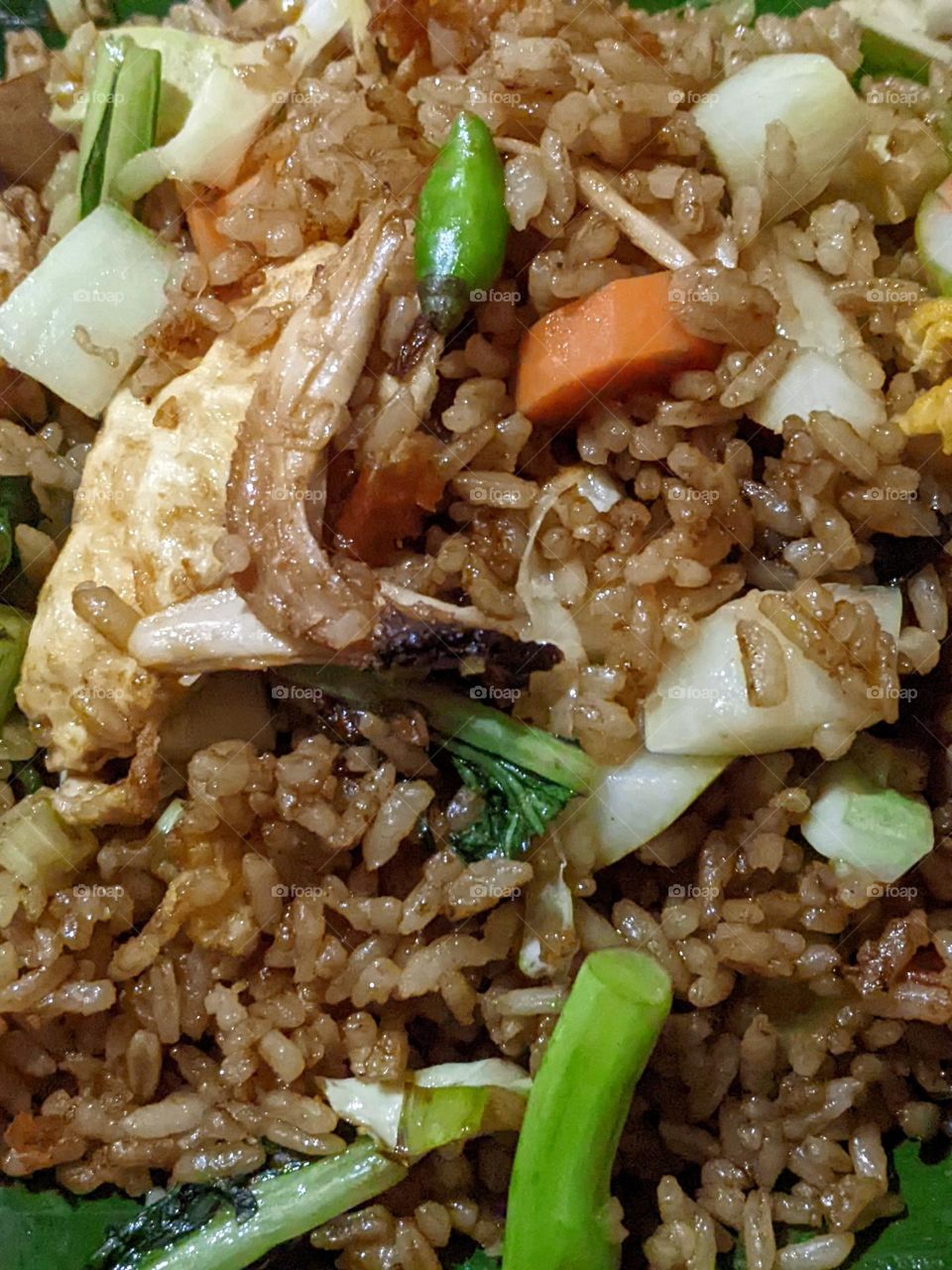 fried rice mixed with eggs and vegetables.