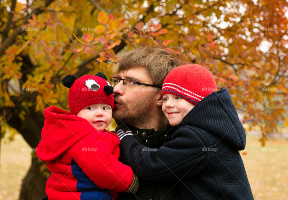 Father carrying his children's