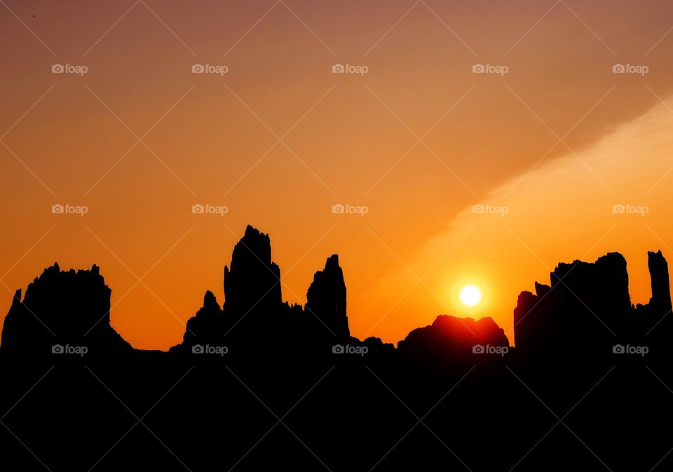 The tree stump is used for the foreground to make the sunset more beautiful.