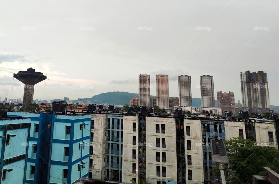 Cityscape Of Mumbai,India
Fusion Of Architecture Multistorey Building 🏙️,Water Tank And Pleasent Mountain in Background 🌅