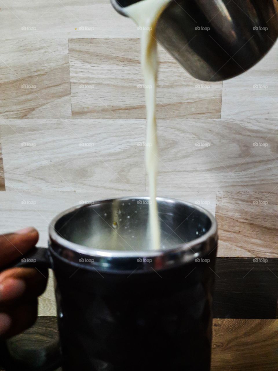 Pouring of Milk in a cup