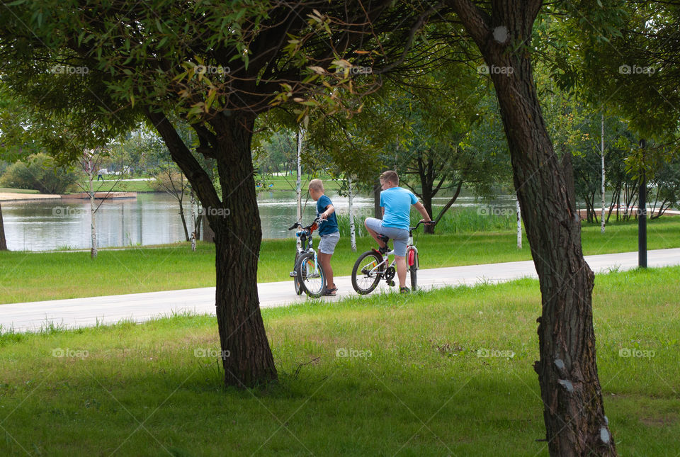 Boys ride their bikes in the Park