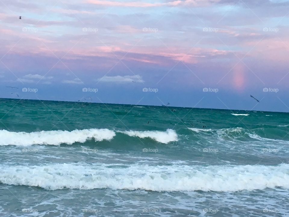 Miami beach surf at sunset