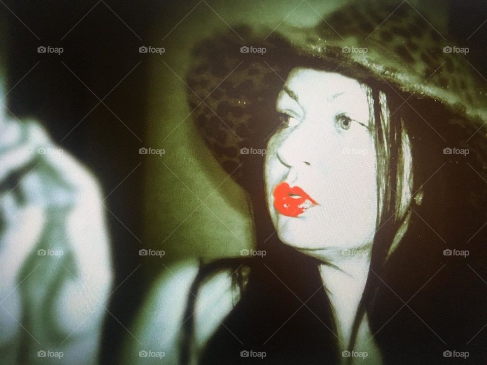 Selfie in a mirror with red lips and a hat