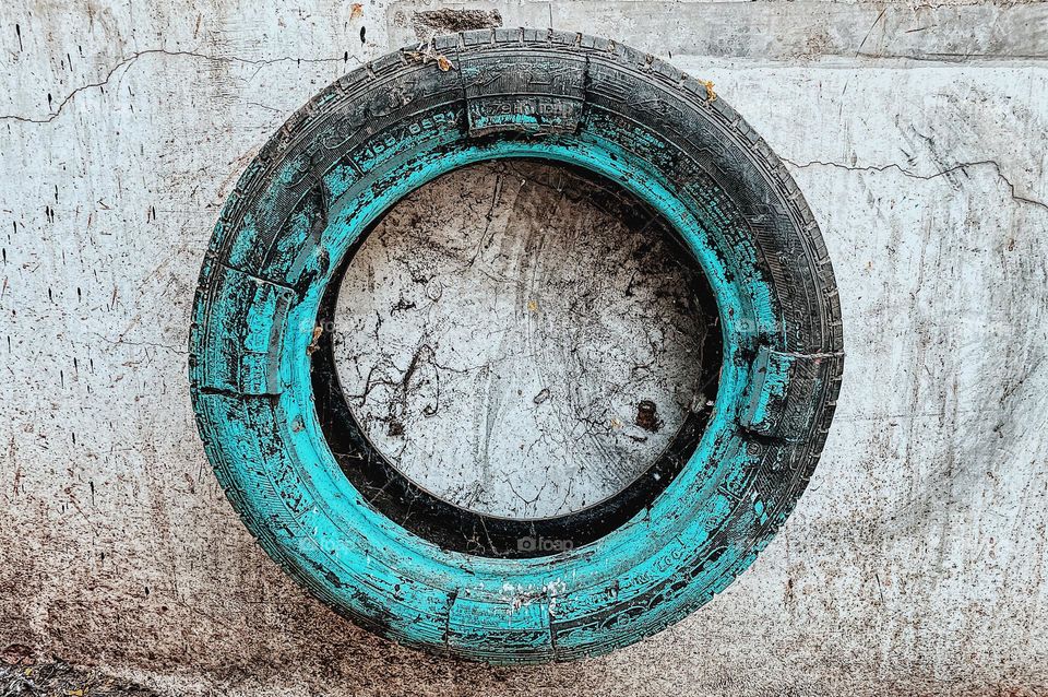 Painted tire in India, painted teal, tires painted with teal, understanding India, colorful culture, tires as decoration 