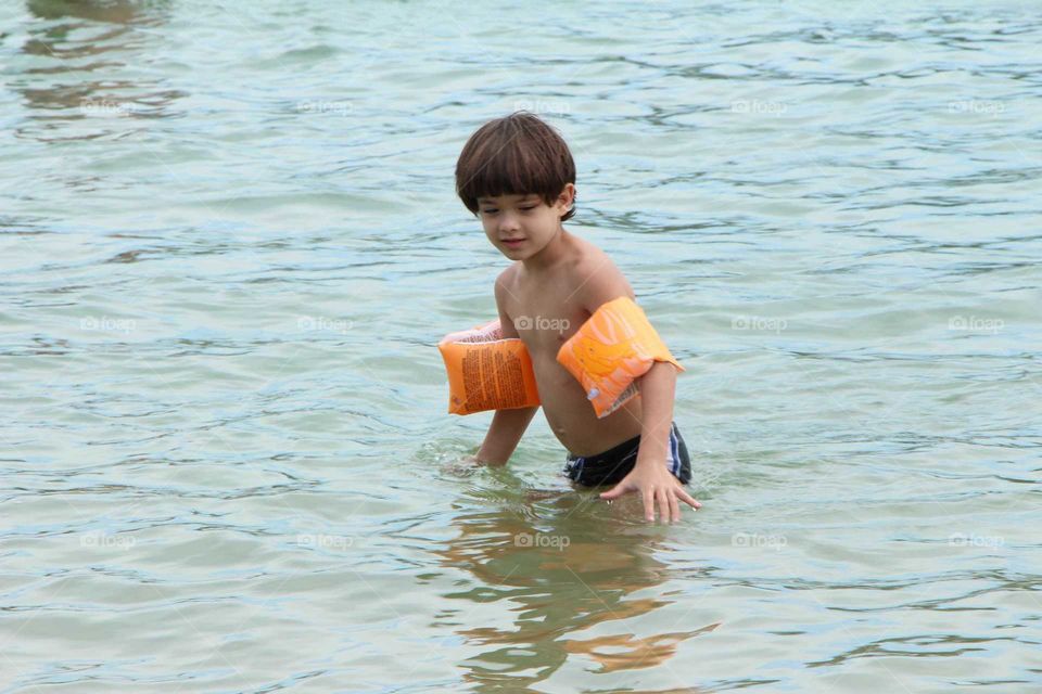 Boy playing in the waters of the beach