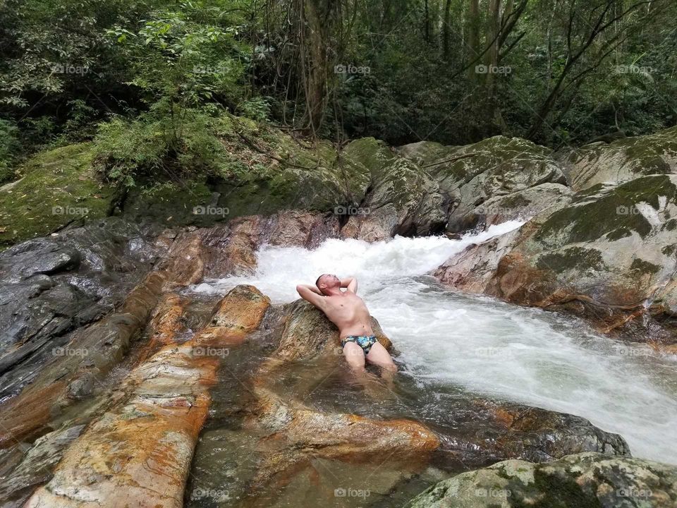 Relaxing and recharging in ice cold river water near Minca, Magdalena, Colombia