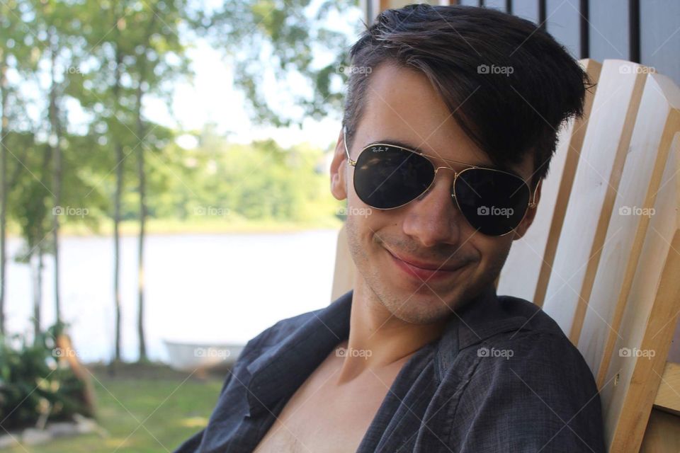 Justin my amazing and always reliable model shows off his ray bands while relaxing on the deck 