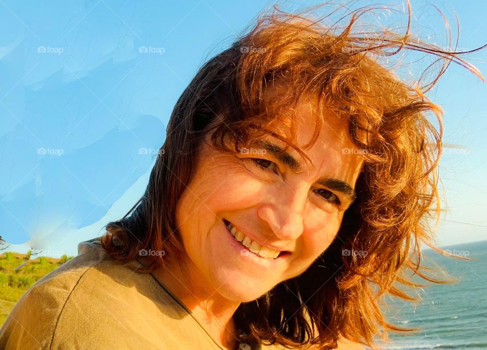 Woman with brown hair at sunset light 