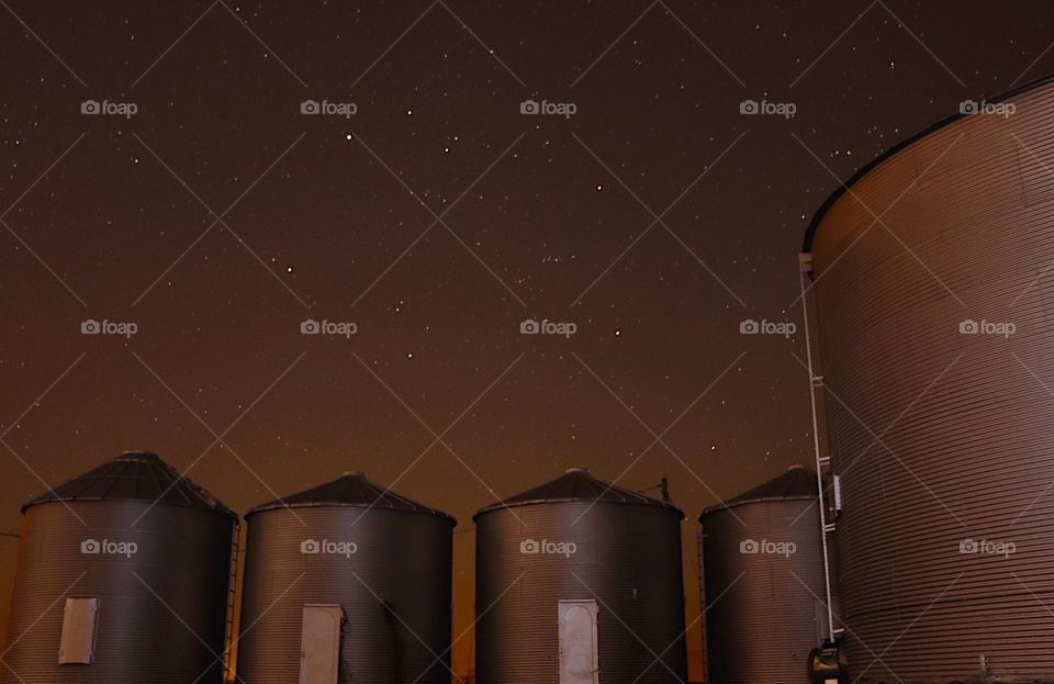 Grain bins full of beans under the heavens 