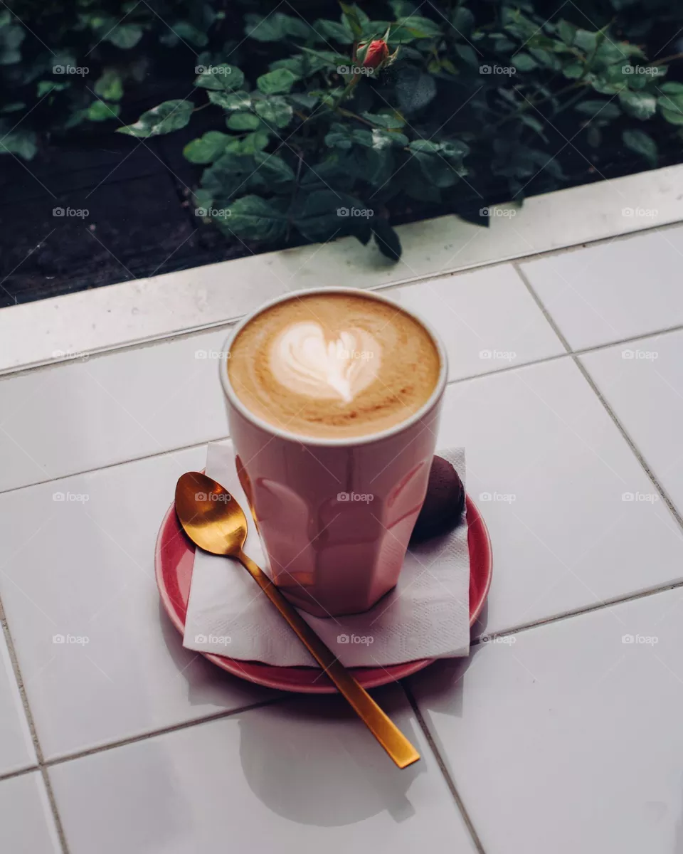 Pink coffee cup with latte art heart 