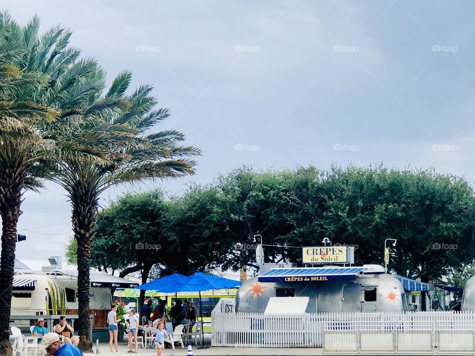 Summertime stroll through Seaside. The palm trees, umbrellas and vendors are all out for summer.