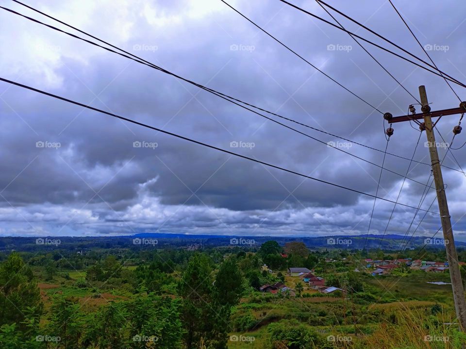 Landscape of mountains, grasslands and electric poles in Doloksanggul District, North Sumatra Province, Indonesia