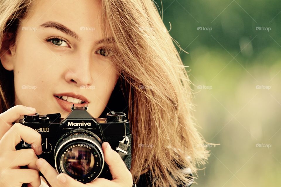 Girl with an analogue camera