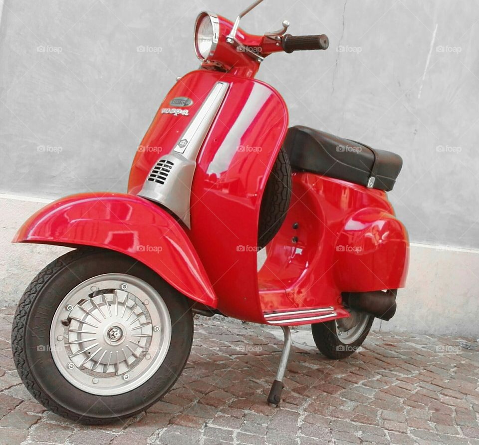 A red Piaggio Vespa