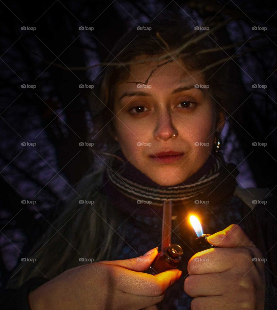 young woman smoking in small pipe