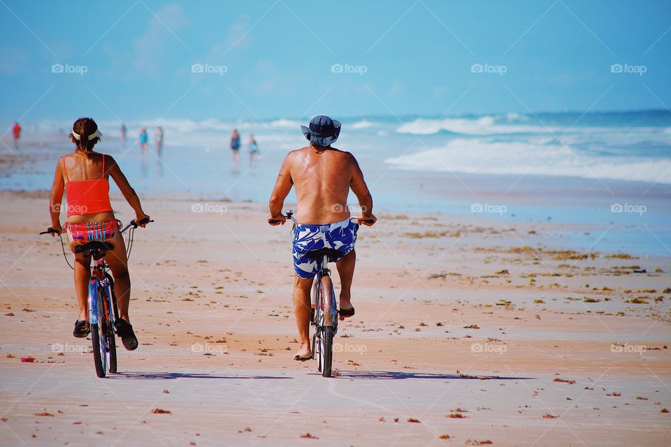 Beach lover cycling in summer 