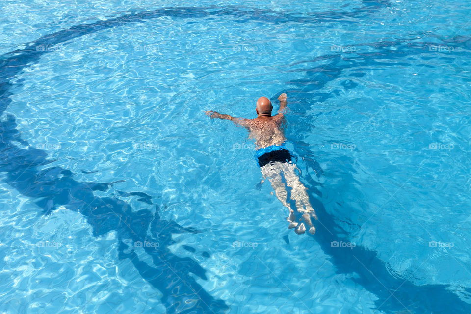 Morning daily routine, swimming in the pool, keeps man healthy and fit