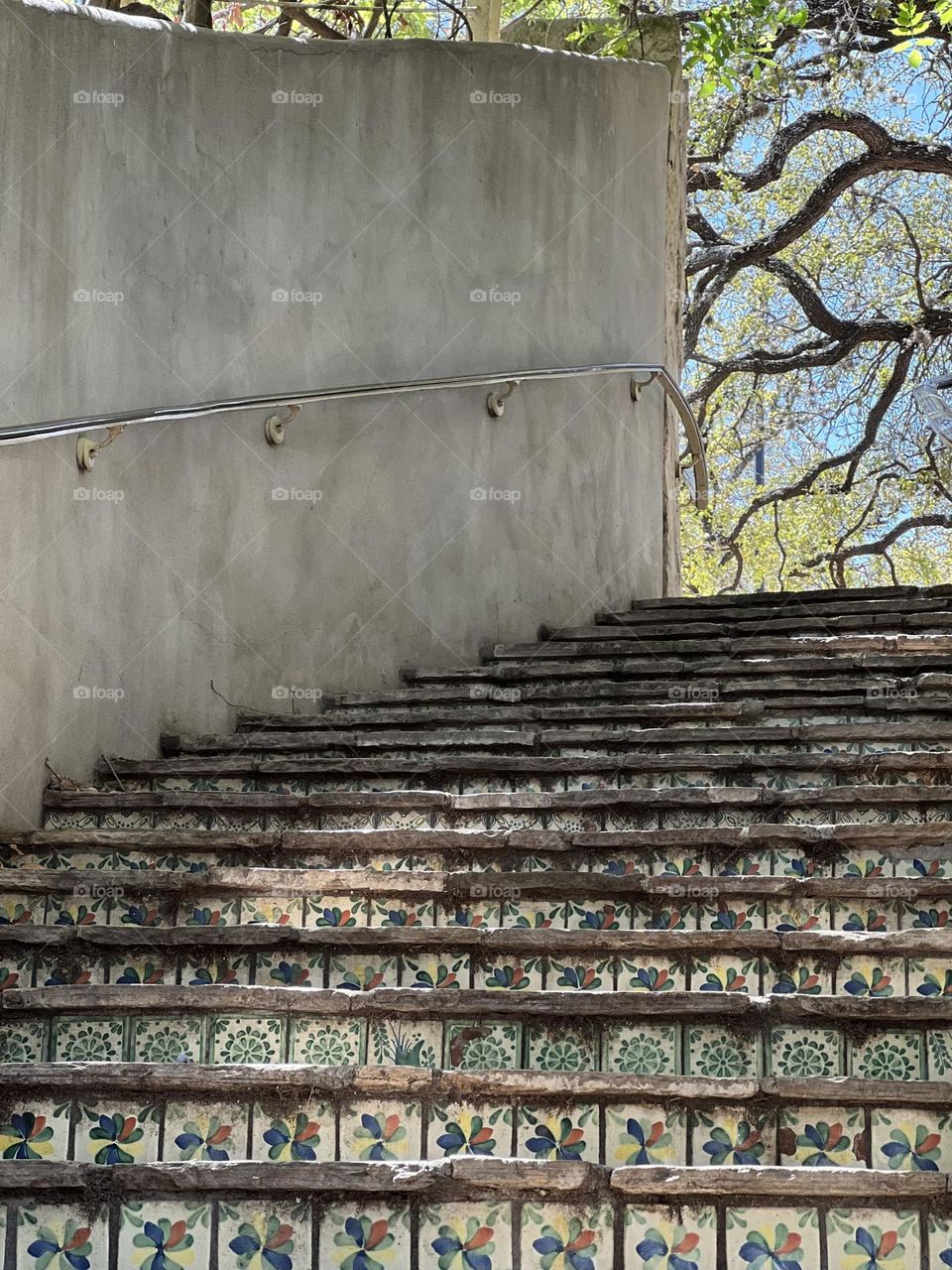 Beautiful Tile steps in San Antonio leading to the blue skies and leafing trees