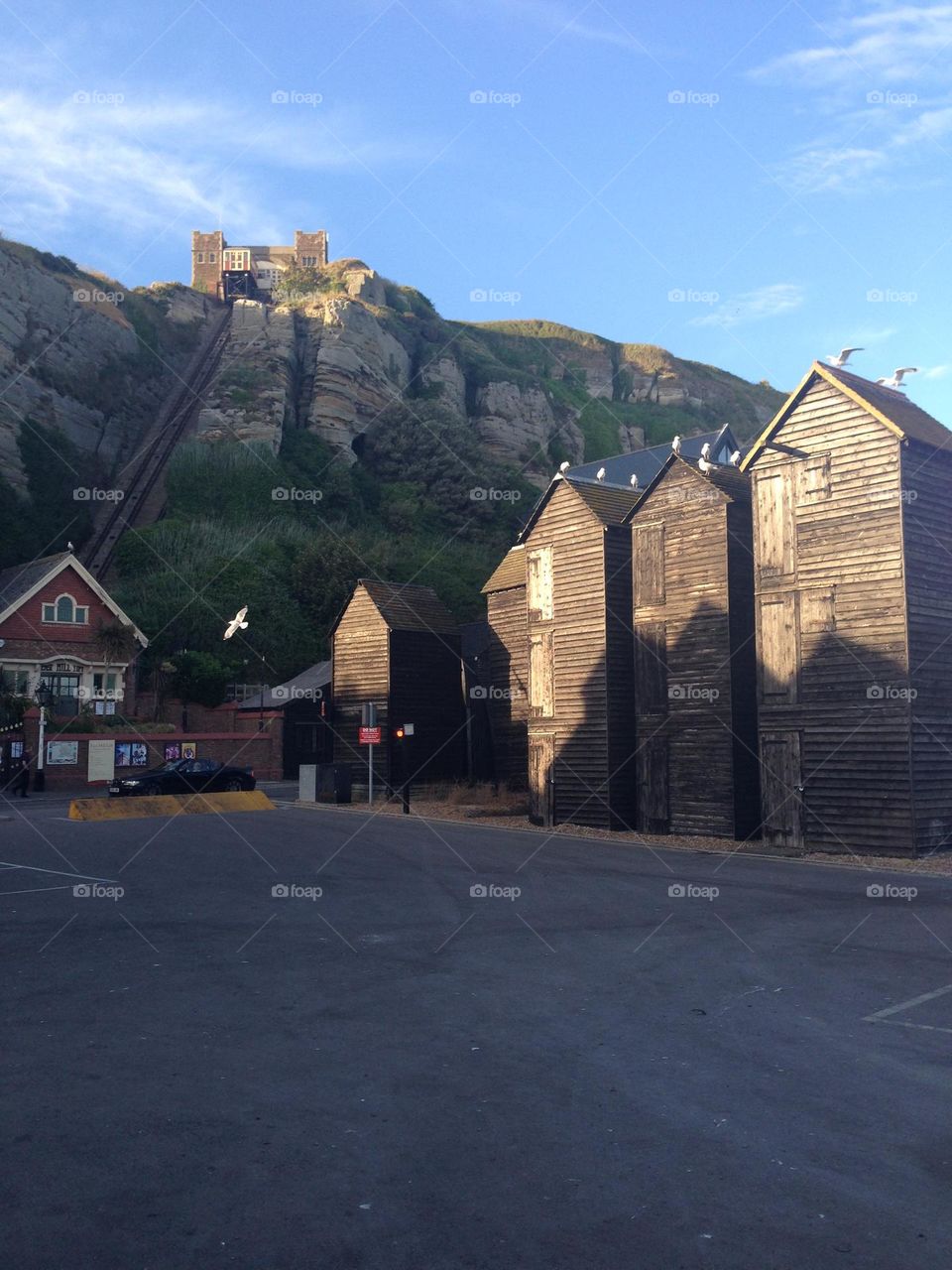 Traditional fishing net huts with a view of the East Hill Cliff railway. Rock-a-Nore, Hastings. 