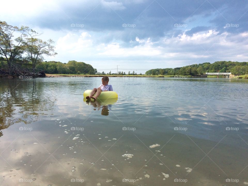 Just floating . My god son enjoying the end of a hot summer day in Sandwich, MA on his float