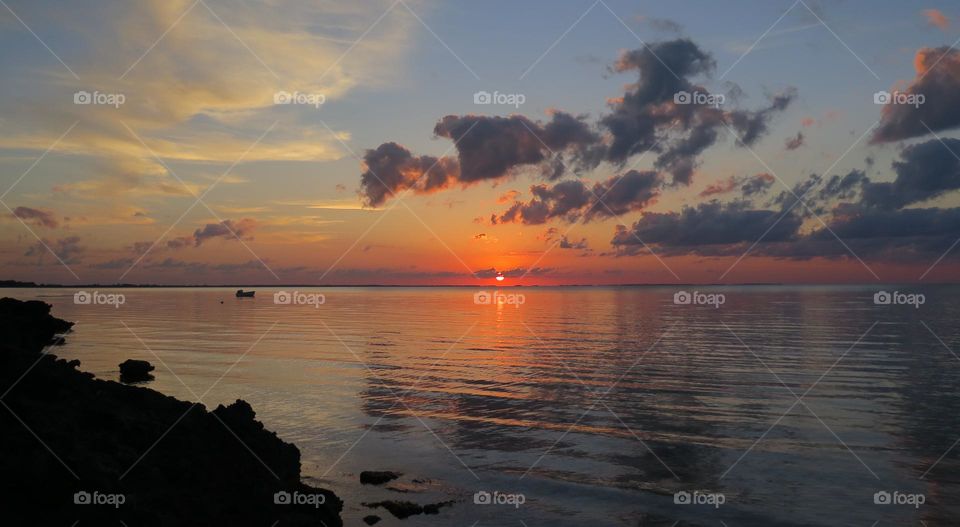 Vibrant beach sunset with clouds