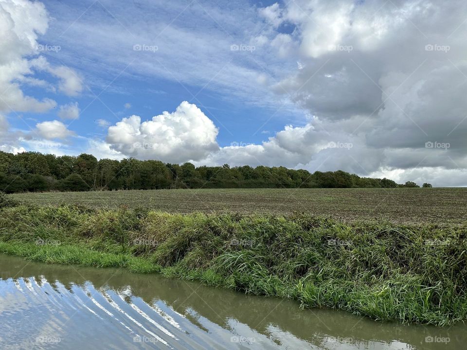 Beautiful weather for narrowboat cruise on Oxford canal late summer vacation in England lovely sky cool clouds horizon treeline water bank