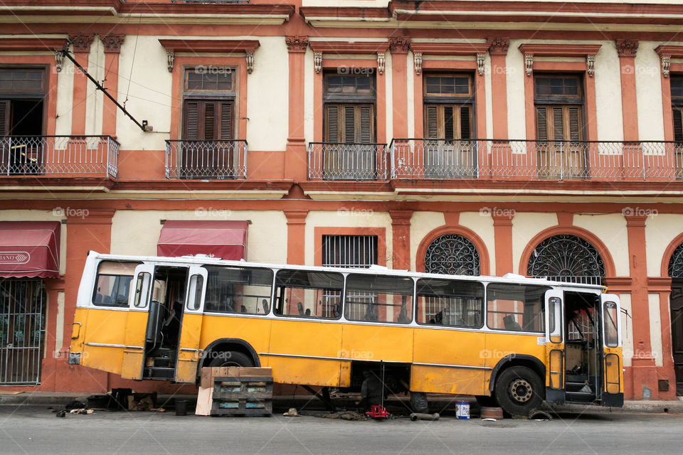 The broken bus in foreground of building. Cuba. Habana.