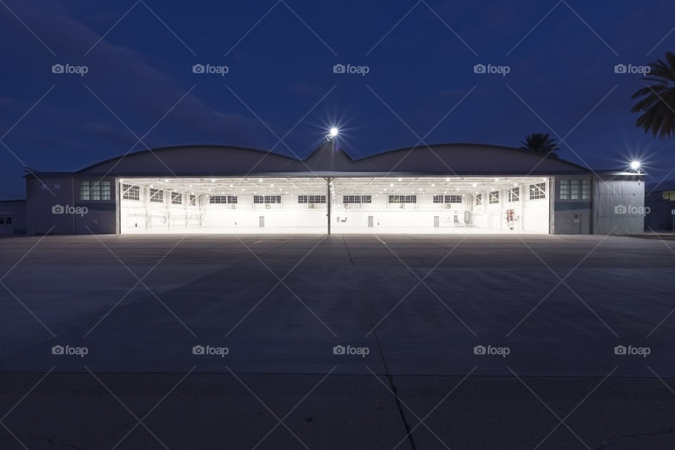 Standing Outside Under Night Sky Looking Into Airport Hangar
