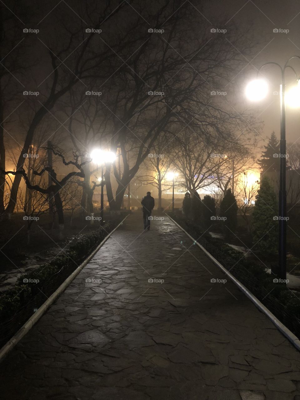 Alone person in a foggy night 