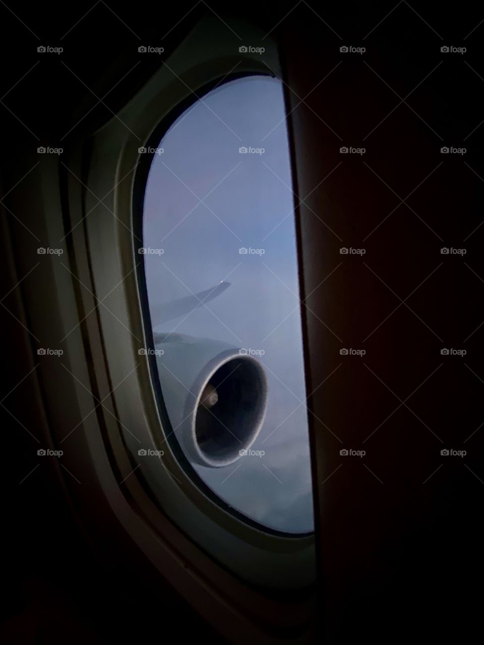 View out the window of the wing and engine of a Boeing 777 flying from Miami Florida to Los Angeles California 