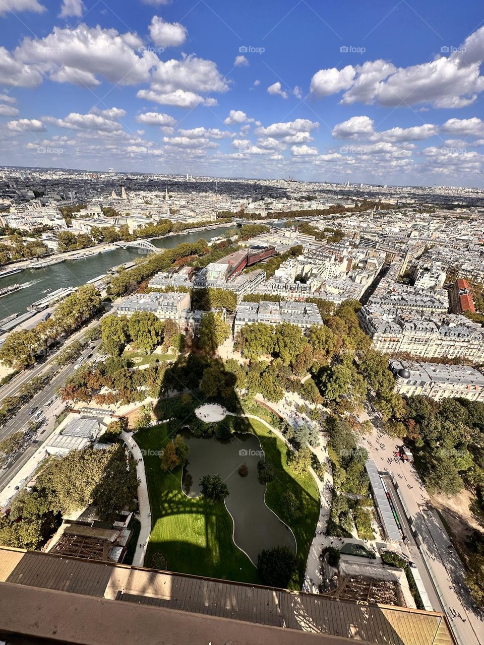 A moment frozen in time: the juxtaposition of the Eiffel Tower's shadow against the bustling cityscape, a reminder of Paris mesmerizing allure.