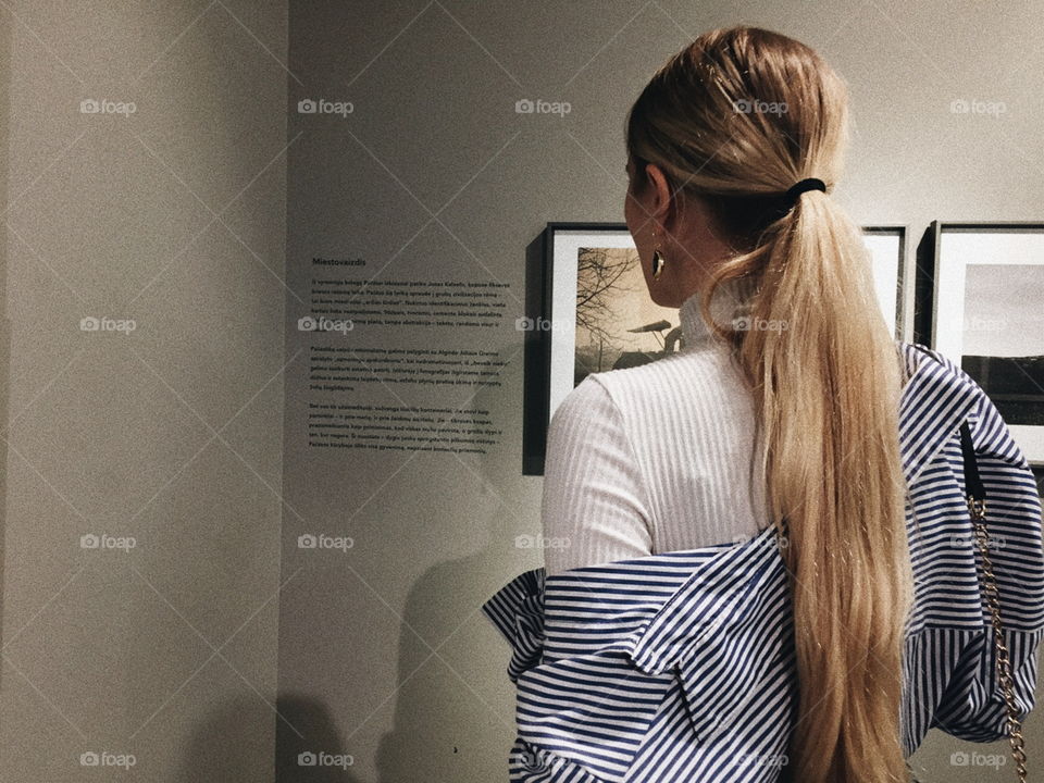 girl looking at art in a gallery