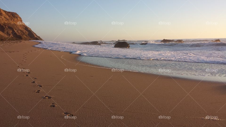 Serene, empty beach in Santa Cruz, California with one set of footprints