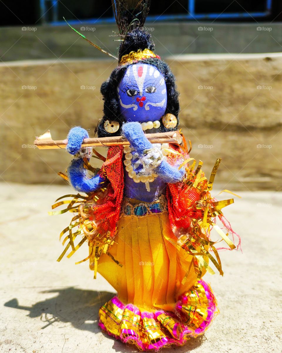 Krishna stands on a flute and it is a beautiful handmade art