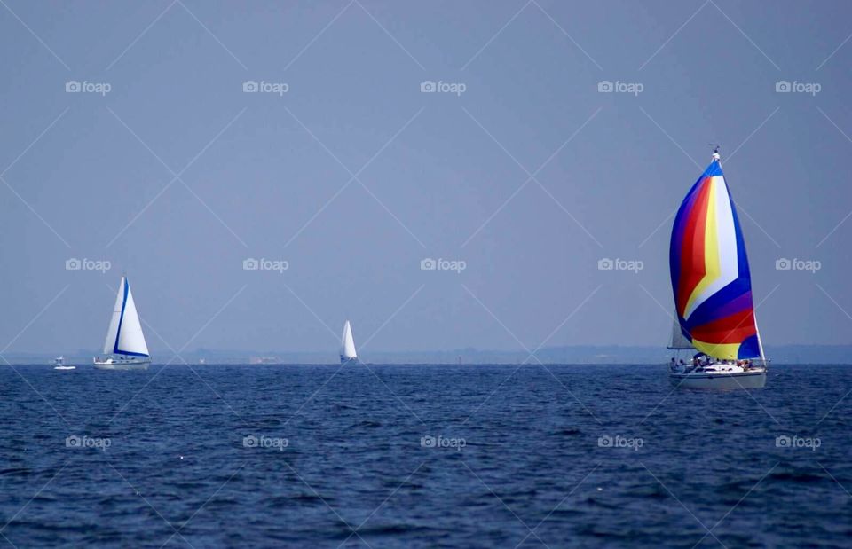 Colorful sailboat in a sea of white