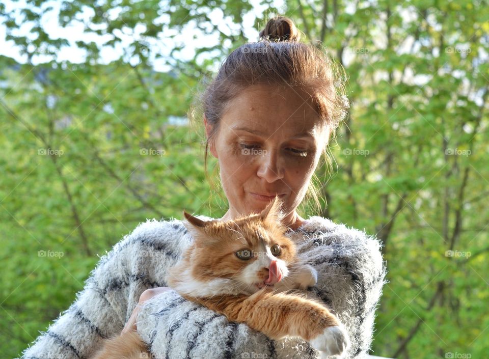 woman portrait and ginger cat pet green leaves background