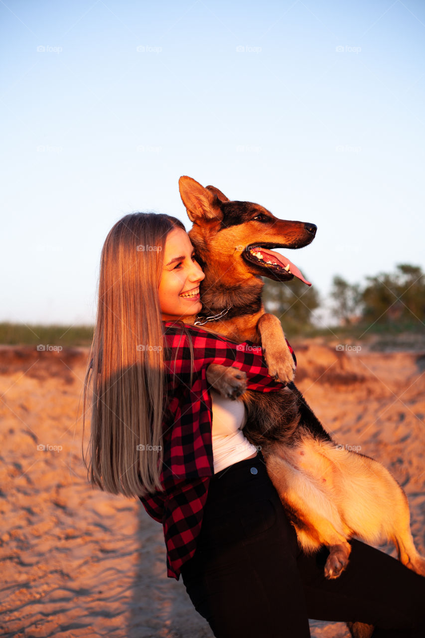 happy woman holding a dog in her arms