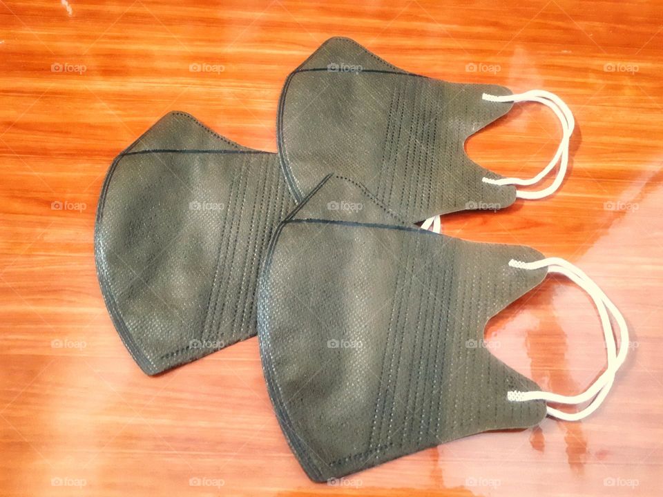 a display of brown masks on ceramic with brown wooden nuances