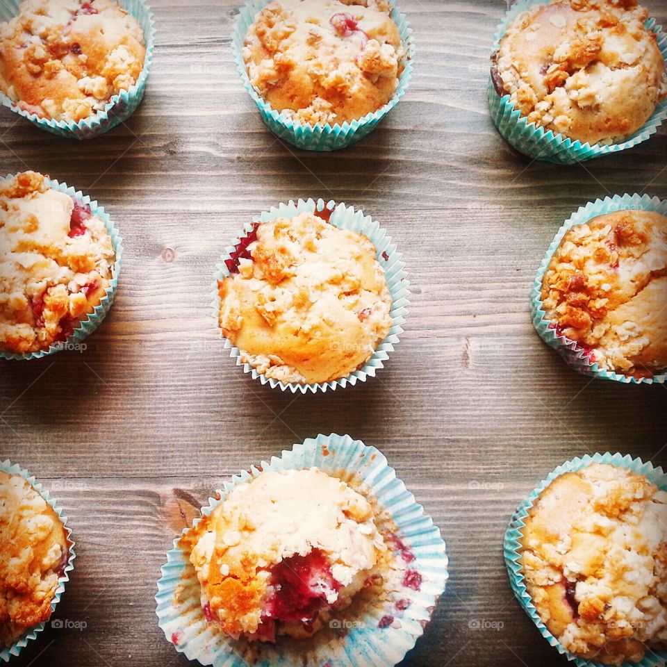 Raspberry muffins in a row