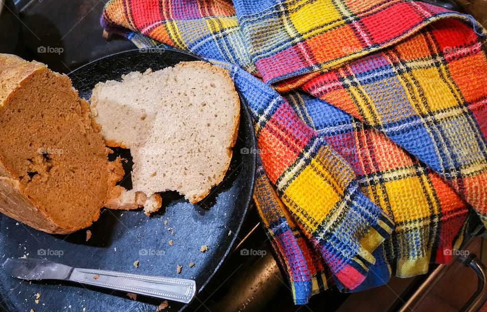 Freshly baked homemade rye bread and a tea towel