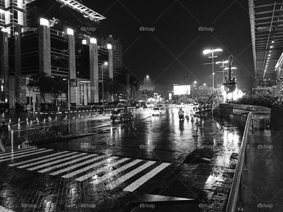 City lights reflecting on the wet pavement